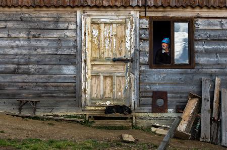 A man, a dog, an empty chair