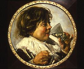 Half-length portrait of a laughing boy with a wine