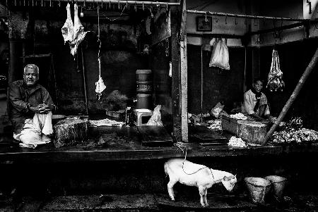 Two butchers on a street in Bangladesh.