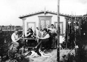 Playing skat outside summerhouse / 1906