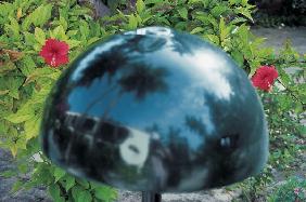 Garden lamp-shade under watchful eyes of two red hibiscus (photo) 